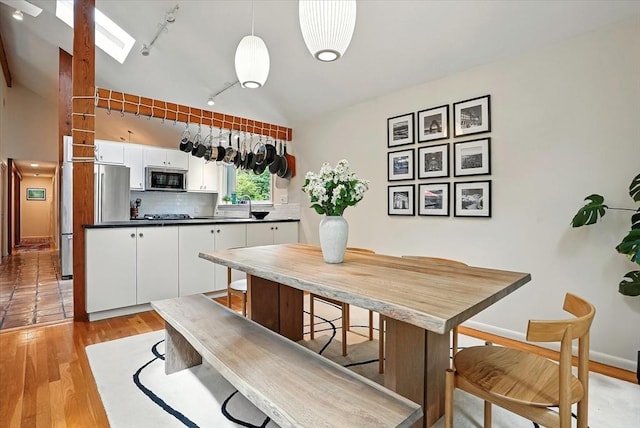 13 Robinwood Rd, Acton, MA 01720 - dining room with light wood-style floors, a skylight, track lighting, and baseboards
