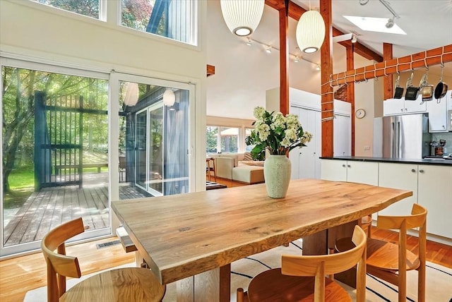 13 Robinwood Rd, Acton, MA 01720 - dining space with rail lighting, high vaulted ceiling, and light wood-type flooring