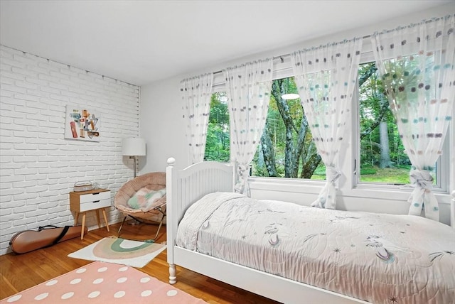 13 Robinwood Rd, Acton, MA 01720 - bedroom featuring brick wall and wood finished floors
