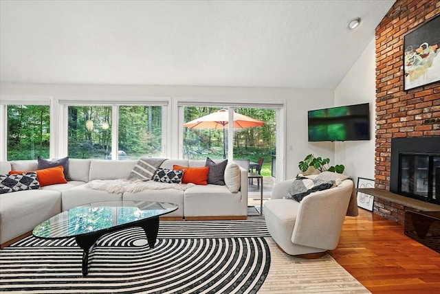 13 Robinwood Rd, Acton, MA 01720 - living area featuring vaulted ceiling, a fireplace, and wood finished floors