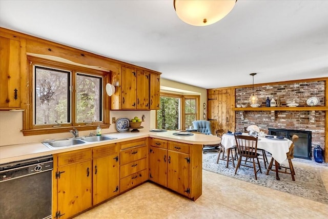 3 Five Cors, Barnstable, MA 02632 - kitchen featuring dishwasher, light countertops, a peninsula, a brick fireplace, and pendant lighting