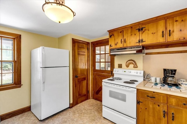 3 Five Cors, Barnstable, MA 02632 - kitchen with white appliances, under cabinet range hood, light countertops, and brown cabinetry