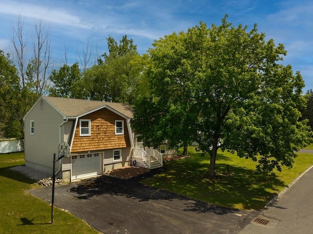 7 Wintergreen Cir, Methuen, MA 01844 - view of front facade with asphalt driveway, a garage, and a front lawn