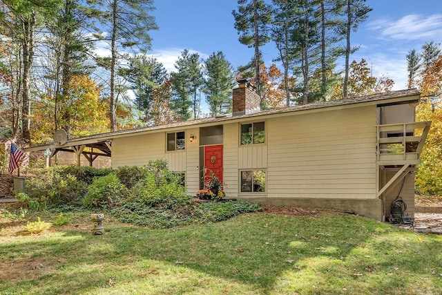 view of front of property with a front yard and a chimney