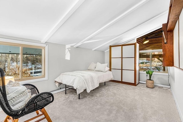 bedroom with lofted ceiling with beams, carpet floors, and baseboards