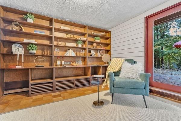 sitting room featuring a textured ceiling and tile patterned floors