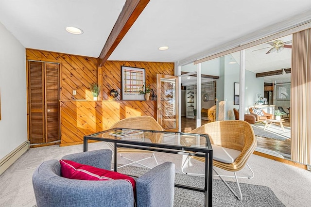 interior space with recessed lighting, wooden walls, baseboards, baseboard heating, and beam ceiling