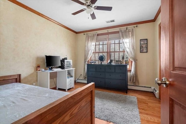 bedroom with ceiling fan, baseboard heating, crown molding, and light wood-type flooring