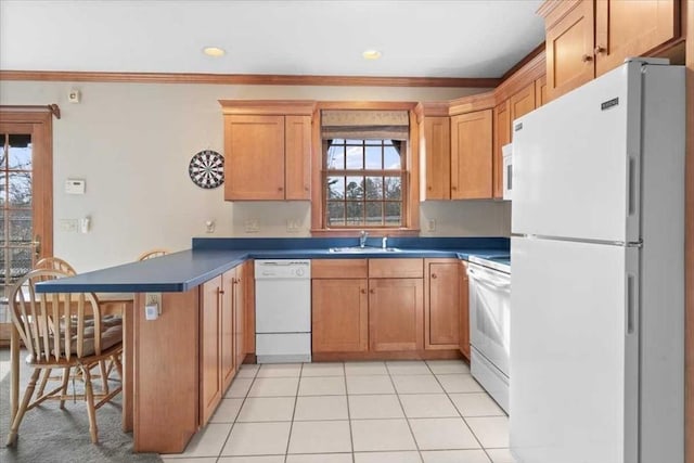 kitchen featuring kitchen peninsula, sink, white appliances, ornamental molding, and light tile patterned floors