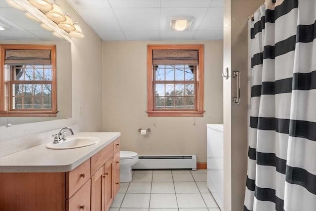 bathroom with toilet, plenty of natural light, vanity, and a baseboard radiator