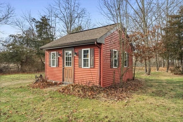 view of outdoor structure featuring a lawn