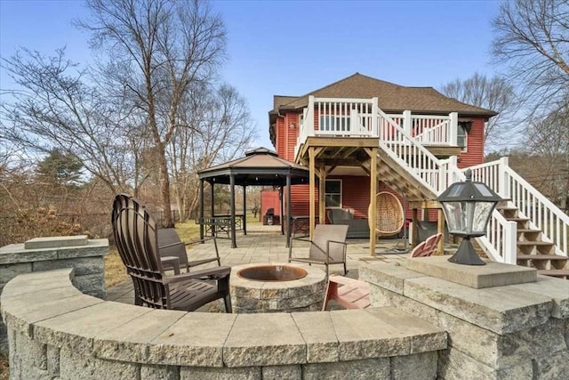 rear view of house featuring a patio area, a gazebo, and a fire pit