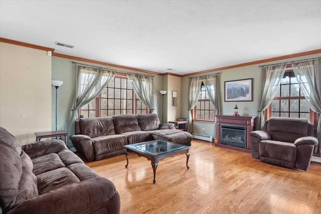 living room featuring baseboard heating, crown molding, and light hardwood / wood-style floors