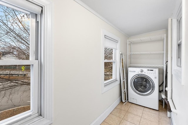 laundry area with washer / clothes dryer, crown molding, a healthy amount of sunlight, and light tile patterned flooring