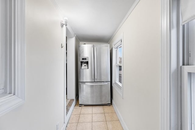 hall with crown molding and light tile patterned flooring