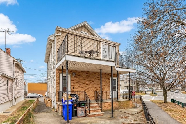 back of property featuring a balcony