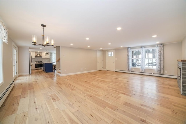 3 Woods Rd, Westminster, MA 01473 - unfurnished living room featuring light wood-style floors, a baseboard radiator, stairs, and recessed lighting