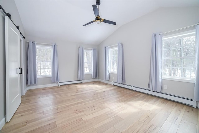 3 Woods Rd, Westminster, MA 01473 - empty room featuring a baseboard heating unit, light wood finished floors, vaulted ceiling, and a barn door