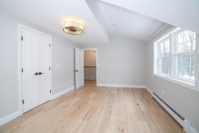 3 Woods Rd, Westminster, MA 01473 - unfurnished bedroom featuring light wood-style floors, baseboards, baseboard heating, and a closet