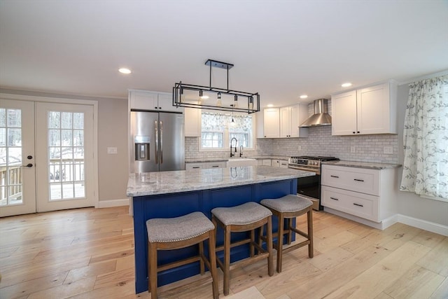 3 Woods Rd, Westminster, MA 01473 - kitchen with appliances with stainless steel finishes, light wood-style flooring, backsplash, and wall chimney exhaust hood
