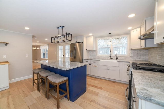 3 Woods Rd, Westminster, MA 01473 - kitchen with stainless steel appliances, a sink, ventilation hood, backsplash, and a center island