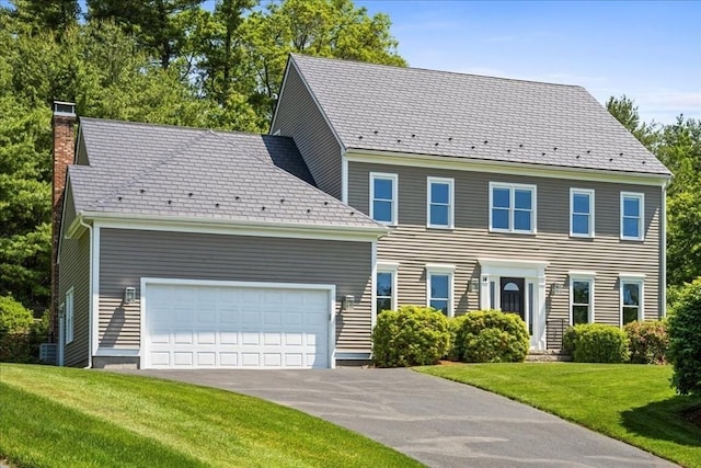 14 Vanessa Dr, Northborough, MA 01532 - colonial-style house featuring a chimney, a front yard, a garage, and driveway