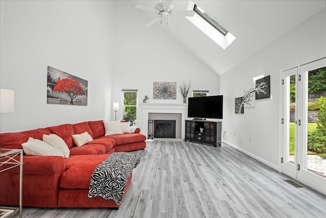 14 Vanessa Dr, Northborough, MA 01532 - living room with high vaulted ceiling, wood finished floors, a glass covered fireplace, a ceiling fan, and a skylight