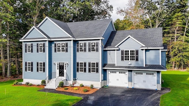 view of front of house featuring a garage and a front yard