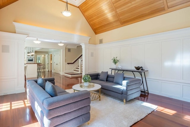 living room featuring ornate columns, high vaulted ceiling, light wood-type flooring, and wooden ceiling