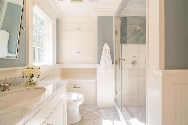 bathroom featuring crown molding, vanity, toilet, and an enclosed shower