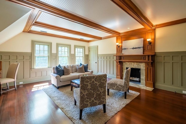 living room featuring hardwood / wood-style floors, a fireplace, ornamental molding, and beamed ceiling