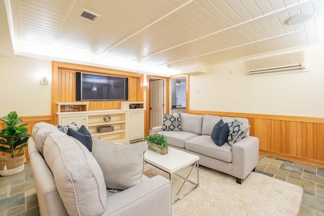 living room featuring wooden ceiling, a wall unit AC, and wood walls