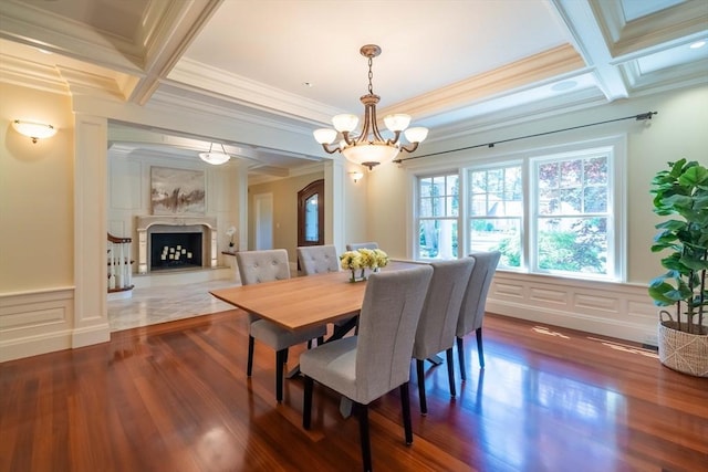 dining space featuring beamed ceiling, a premium fireplace, and coffered ceiling