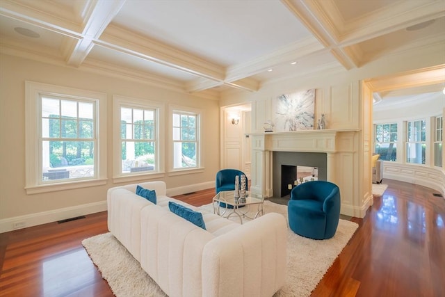 living room featuring plenty of natural light, coffered ceiling, and beam ceiling