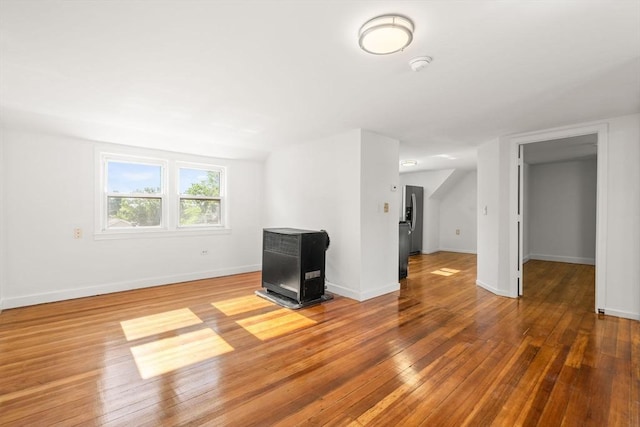 178 Cohasset St, Worcester, MA 01604 - unfurnished living room featuring wood finished floors and a wood stove