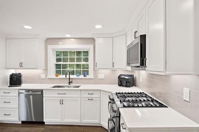 10 Carlisle Rd Unit 10, Bedford, MA 01730 - kitchen featuring appliances with stainless steel finishes, white cabinetry, light countertops, decorative backsplash, and recessed lighting