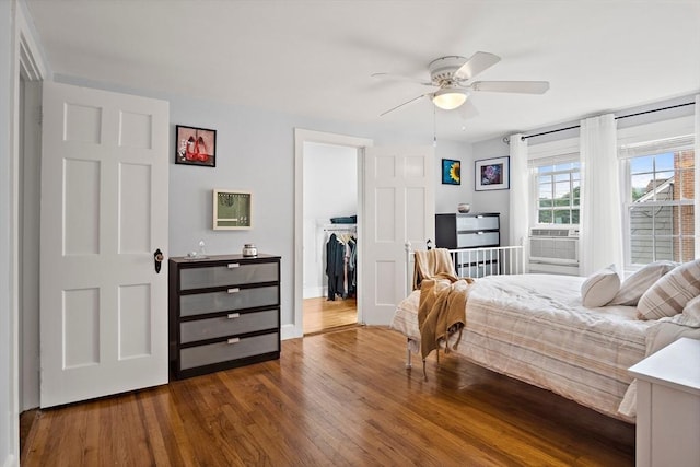 10 Carlisle Rd Unit 10, Bedford, MA 01730 - bedroom featuring dark wood-style flooring, a ceiling fan, and a walk in closet