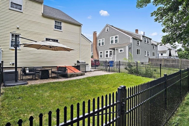 10 Carlisle Rd Unit 10, Bedford, MA 01730 - rear view of property with a patio and a fenced backyard