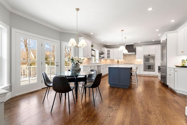 dining area featuring crown molding, recessed lighting, and dark wood finished floors