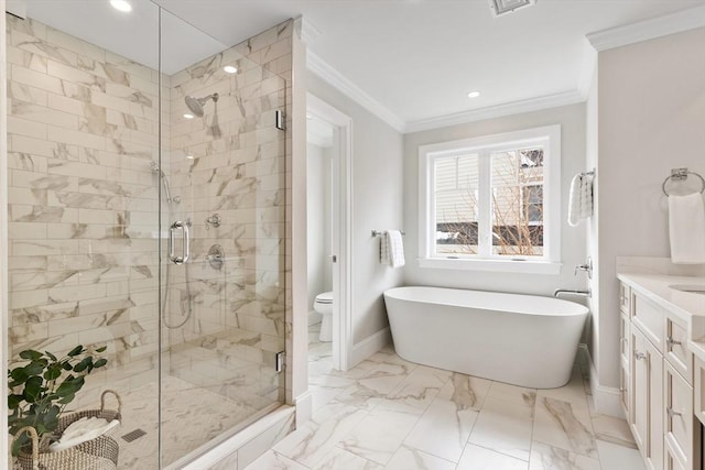 bathroom with marble finish floor, a freestanding bath, ornamental molding, a stall shower, and baseboards