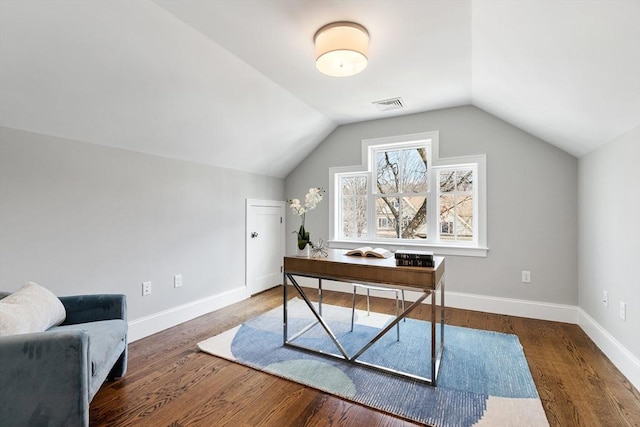 office space with lofted ceiling, baseboards, visible vents, and wood finished floors