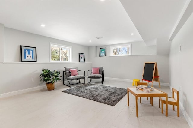 living area with recessed lighting and baseboards