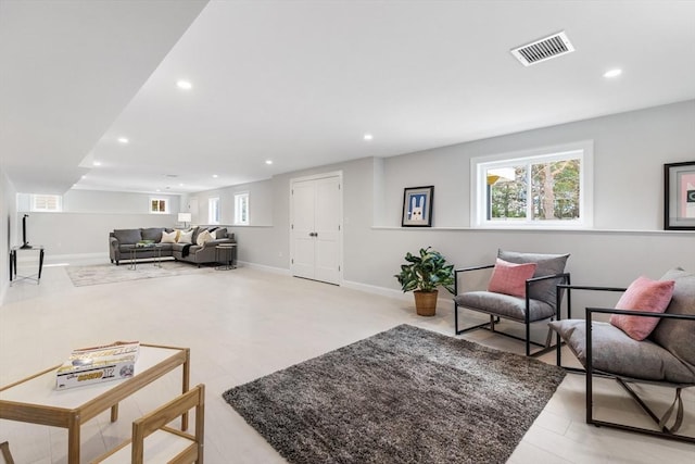 living area featuring visible vents, a wealth of natural light, and recessed lighting