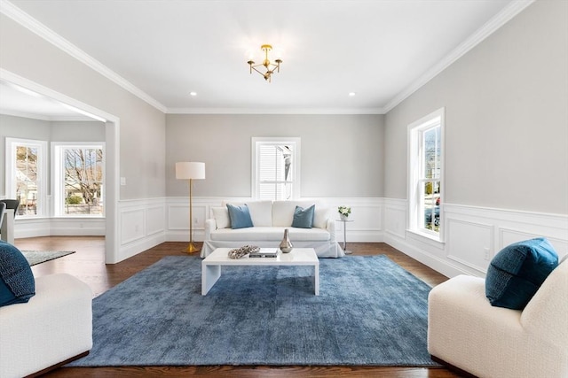 living room featuring plenty of natural light, ornamental molding, and dark wood finished floors