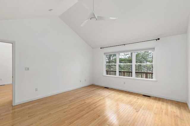 empty room featuring visible vents, light wood-style flooring, ceiling fan, and vaulted ceiling