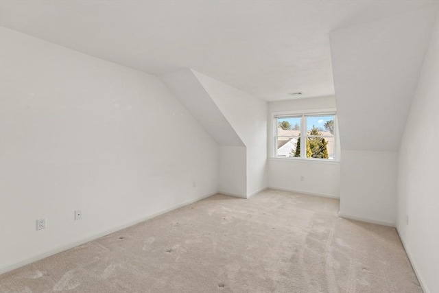 bonus room featuring lofted ceiling, visible vents, baseboards, and carpet floors