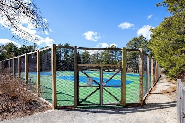 view of tennis court featuring fence