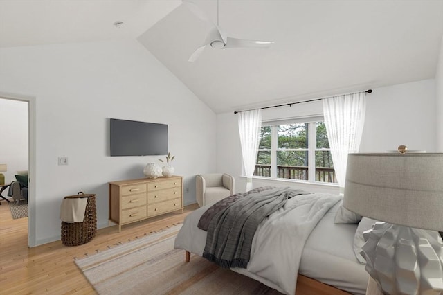 bedroom with light wood-style flooring, a ceiling fan, and high vaulted ceiling