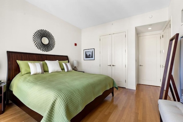 bedroom featuring light wood finished floors and a closet