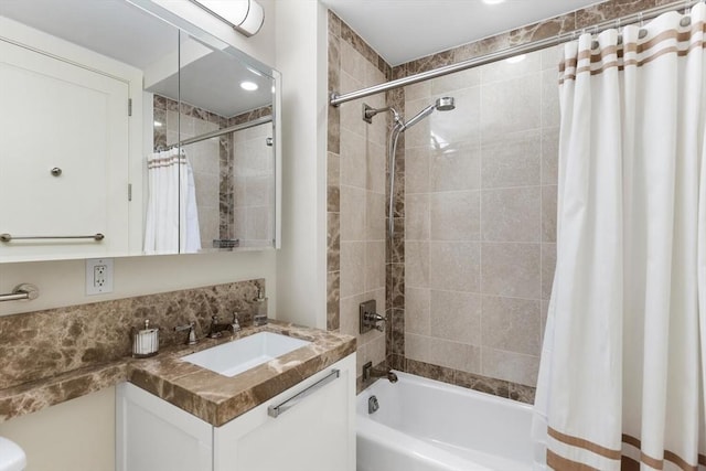 bathroom featuring vanity and shower / bath combination with curtain